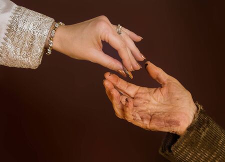 Rich hand giving alms to beggarの写真素材