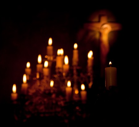 Holy cross and candles lighting in the darknessの写真素材