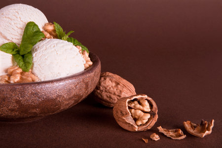 Vanilla ice cream bowl with fresh walnuts