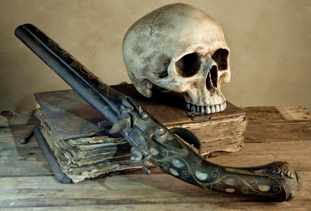 Vintage photo of a skull and pistol as in an old master painting