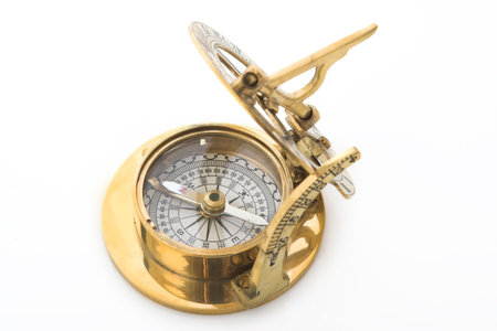 Old gold metal compass on a white background