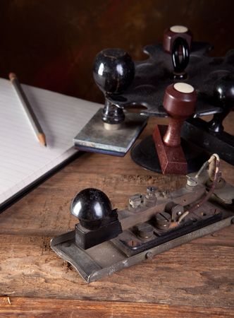Antique morse code telegraph and stamps on vintage deskの写真素材