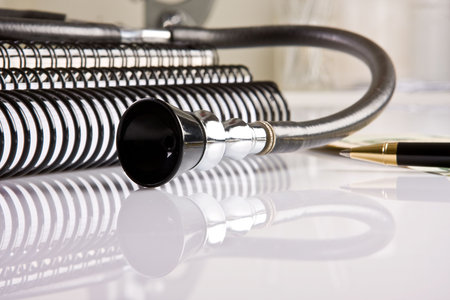 Doctor's desk with a stethoscope and a golden pen