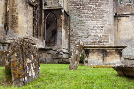 Lichen covered medieval graves of Lacock church in Wiltshire Englandの写真素材