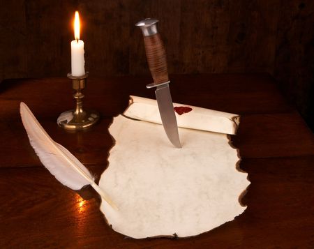 Vintage photo of a dagger cutting into an old documentの写真素材