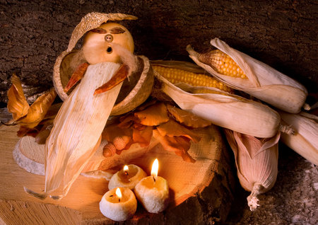 Figurine made of autumn materials like corncobs, acorns, fungi and peppersの写真素材