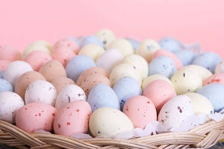 Basket full of pastel colored easter eggsの写真素材