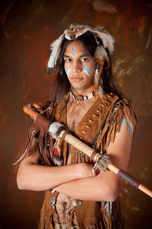 Portrait of an Indian in traditional costume wearing eagle feathers, coyote fur and beadsの写真素材
