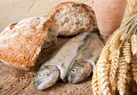 Wine jug, bread and fish as symbols of christian religionの写真素材