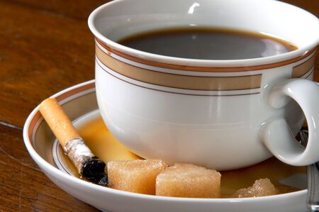 Abandoned cup of cold coffee, with coffee slopped in the saucerの写真素材