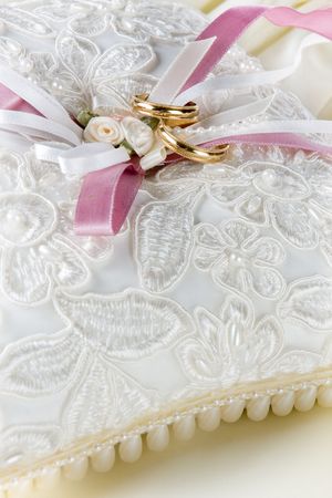Wedding rings lying on a decorated cushionの写真素材