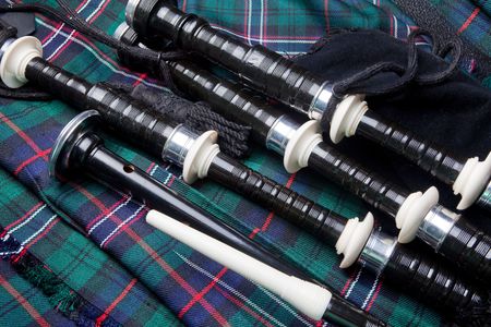 Scottish bagpipes lying on a traditional kiltの写真素材