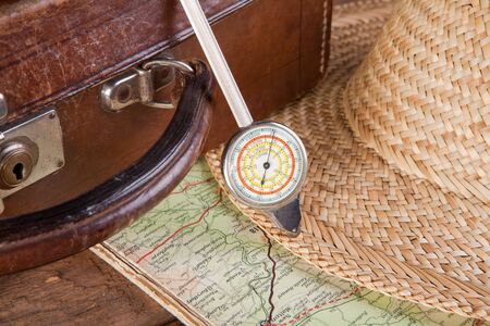 Antique distance meter, map and suitcase of a touristの写真素材