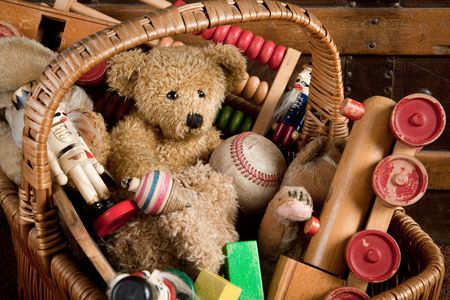 Old basket filled with antique wooden toysの写真素材