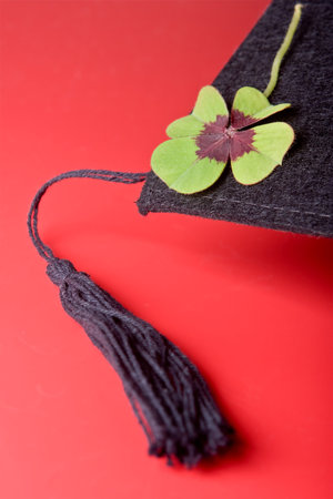 Detail of a good luck cloverleaf on a graduation cap