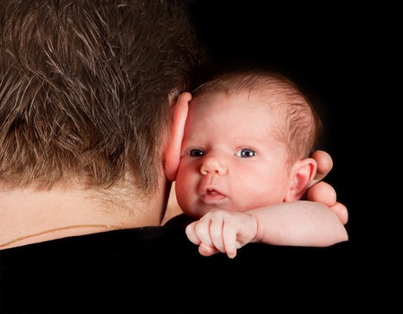 Father holding his twenty days old newborn babyの写真素材