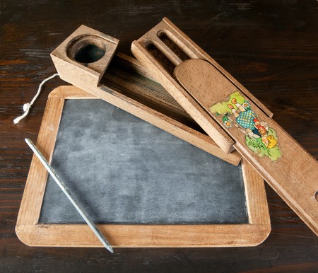 Antique wooden slate and pencil with copy spaceの写真素材