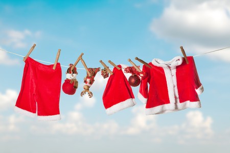 Santa claus laundry hanging on a clothesline in the skyの写真素材