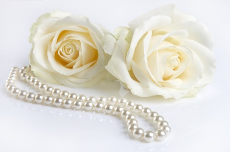 Symphony in white, two white roses and a pearl necklace, as a valentine giftの写真素材