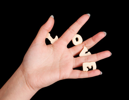 Female hand holding the letters love on valentine's dayの写真素材
