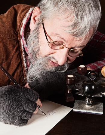 Vintage scene of an old man working in an antique officeの写真素材