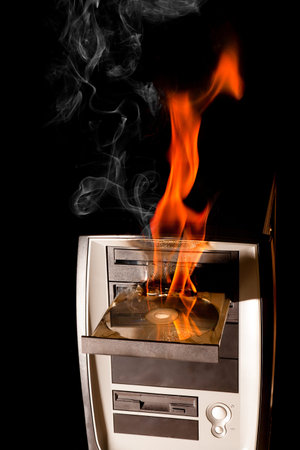 Burning computer and dvd drive on fireの写真素材