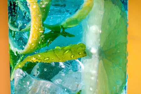 Extreme macro closeup of a blue cocktail drink with lemon slicesの写真素材