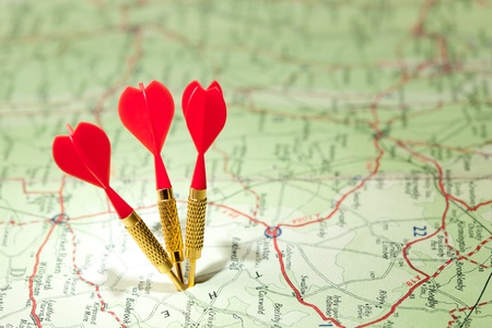 Shallow focus roadmap with three red dartsの写真素材