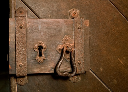 Antique rusty lock on a medieval wooden doorの写真素材