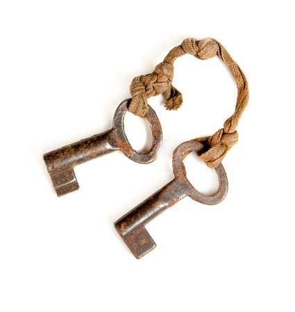 Isolated pair of two small rusty keys on whiteの写真素材