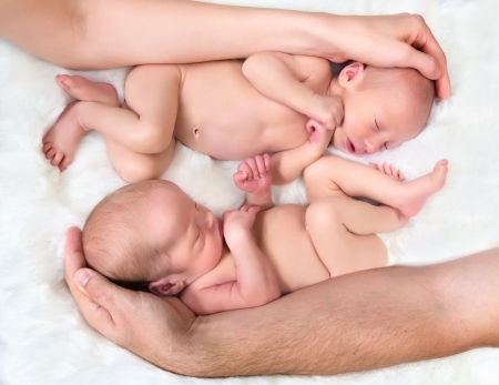 Protecting hands for baby twinsの写真素材