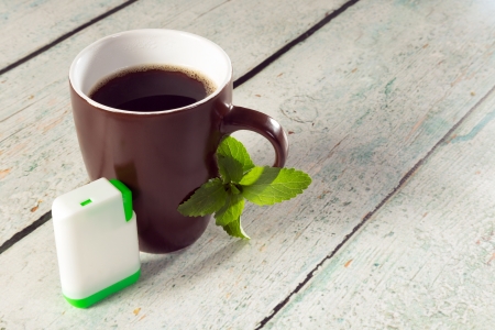 Little white box of stevia tablets as sweetener for a mug of coffeeの写真素材