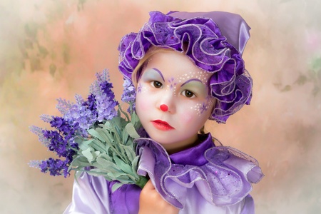 Beautiful portrait of an adorable clown girl with lavender flowersの写真素材