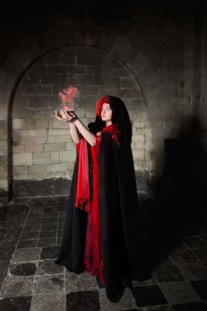 Red sorceress with black cape and red smokeの写真素材