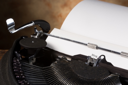 Antique typewriter with an empty page and the word BLOGの写真素材