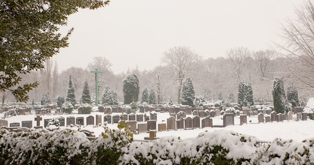 Graveyard on a misty winter morning in the snowの写真素材