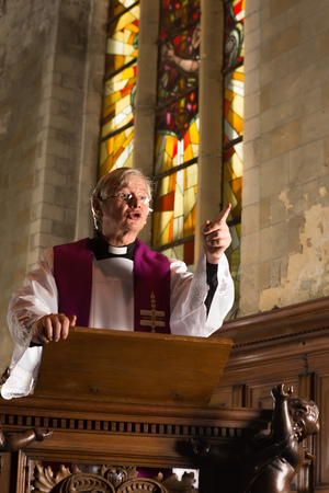 Minister preaching during mass in a medieval abbeyの写真素材