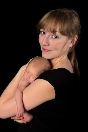 Loving mother holding her ten days old newborn baby girlの写真素材