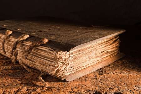 Medieval book of more than 300 years old with a wooden cover on a grungy tableの写真素材