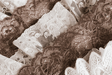 Layers of vintage old lace trims in desaturated colorsの写真素材