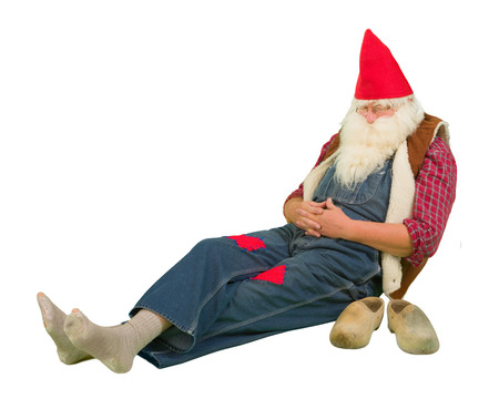 Funny sleeping garden gnome with holes in his socksの写真素材