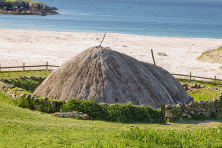 Ancient blackhouse or celtic croft preserved and restorend on a beach on Lewis in the Ouder Hebrides of Scotlandの写真素材