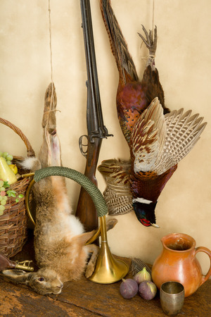 Autumn still life with hunting rifle, pheasant and hareの写真素材