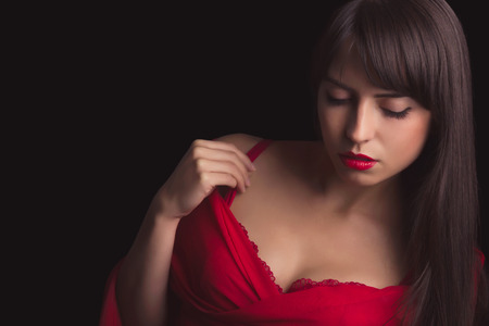Stunning brunette with red lingerie and closeup on cleavageの写真素材