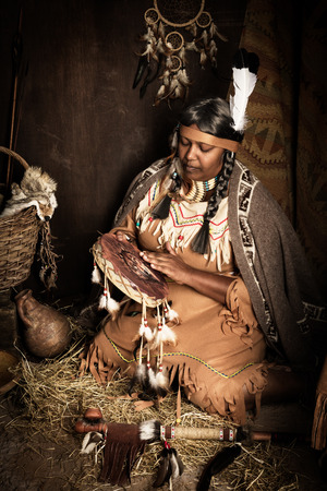 Weathered mature tribal female storyteller talking about heroic timesの写真素材