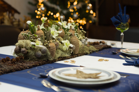 Christmas dinner table with beautiful flower arrangement の写真素材