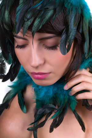 Iridiscent feather headpiece on a beautiful womanの写真素材