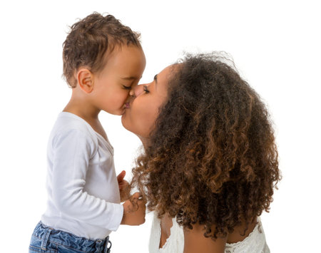 Happy African Ethiopian mother kissing her 18 month old little boyの写真素材