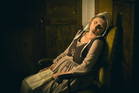 Portrait of a ature woman reading in an Old Master or Renaissance style
