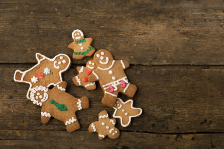 Cute little gingerbread men cookies on a wooden table